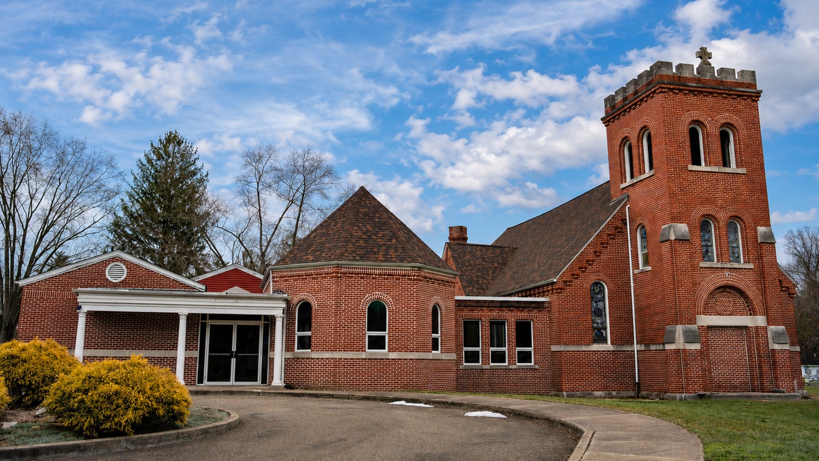 The 1890s brick church in Buchtel, Ohio, with its bell tower and arched windows, now home to Hocking Hills Garment Center