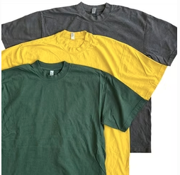 Stack of green, gold, and charcoal dirt-to-shirt T-shirts made from cotton grown in Virginia, spun and knitted in North Carolina, and sewn at HHGC in Ohio