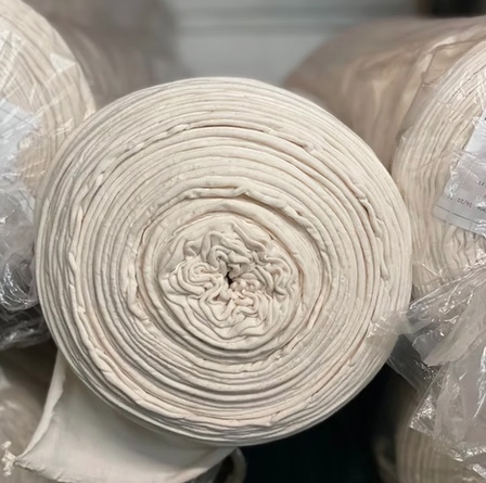 Roll of naturally seeded cotton jersey fabric from Bosselman Farms cotton awaiting cutting