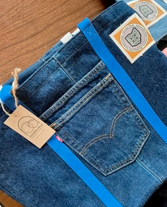 Reclaimed denim tote bag with repurposed jeans pocket and blue webbing, made in collaboration with Circular Thrift
